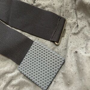 Women’s fashion belt. Black stretch belt. Gray buckle.